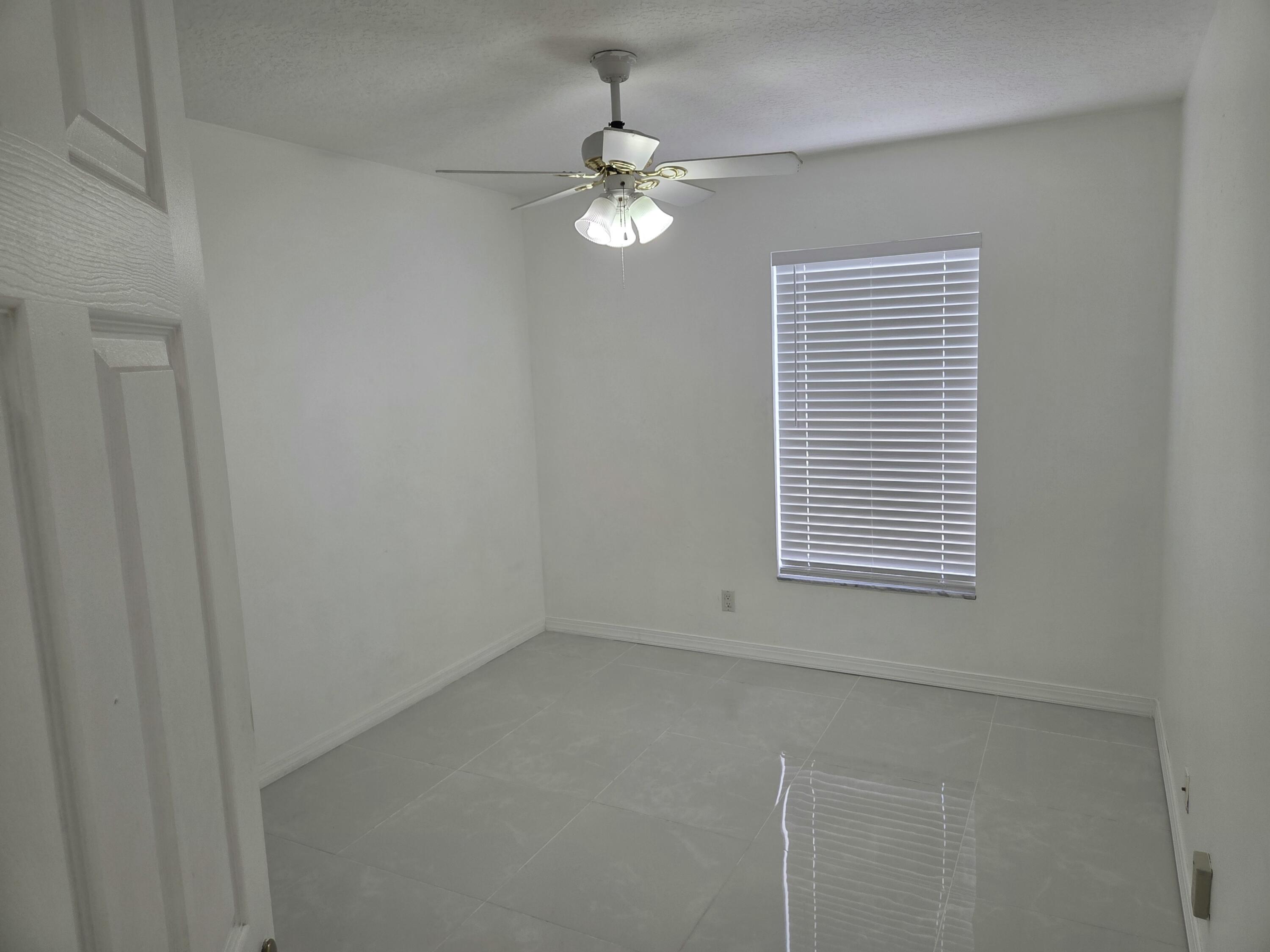 3021 Casa Rio Court Riviera Beach, FL 33418 - Photo 11 of 16 a view of an empty room with a window