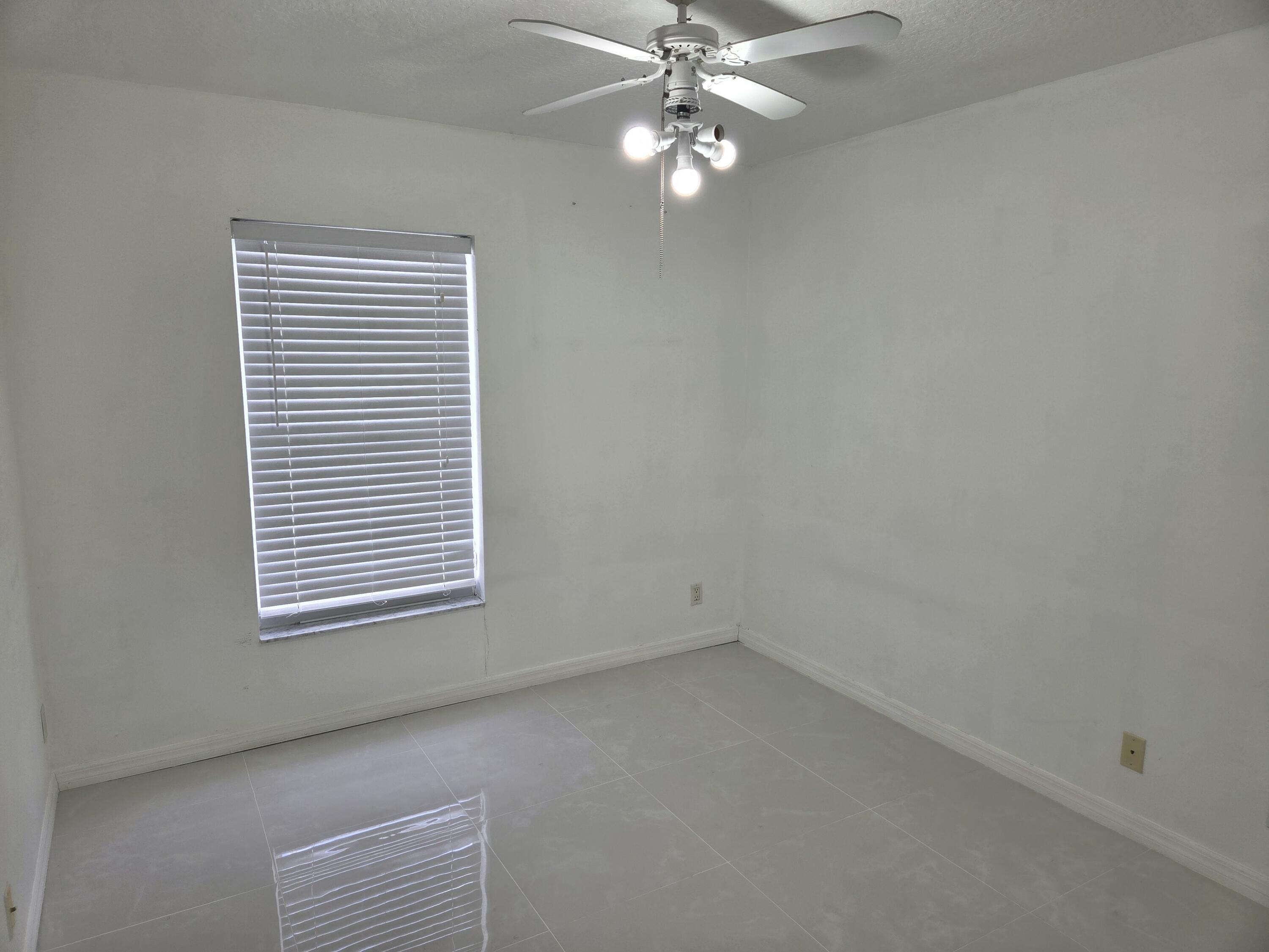 3021 Casa Rio Court Riviera Beach, FL 33418 - Photo 12 of 16 an empty room with a window