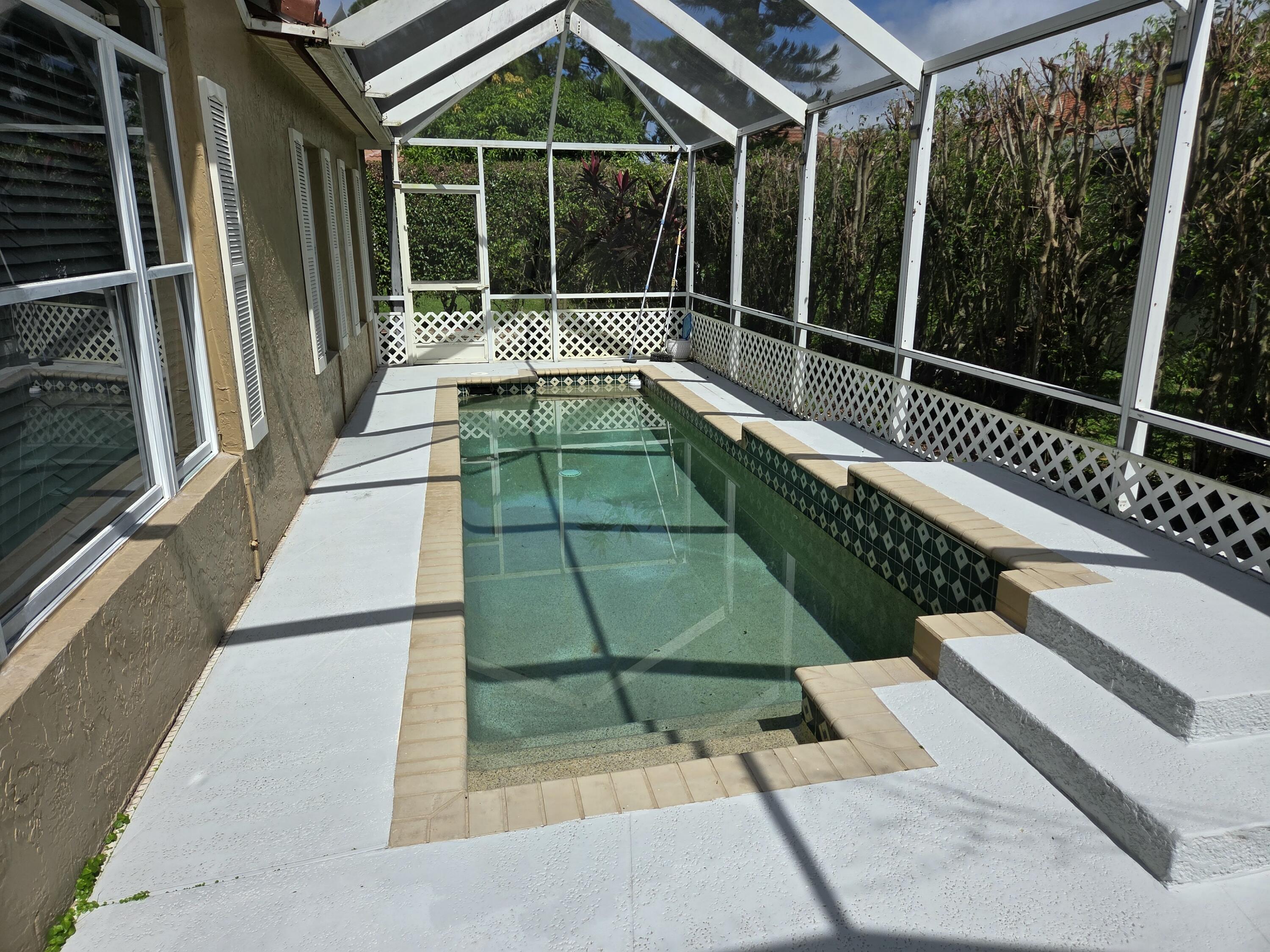 3021 Casa Rio Court Riviera Beach, FL 33418 - Photo 16 of 16 a view of balcony with a large window and wooden floor