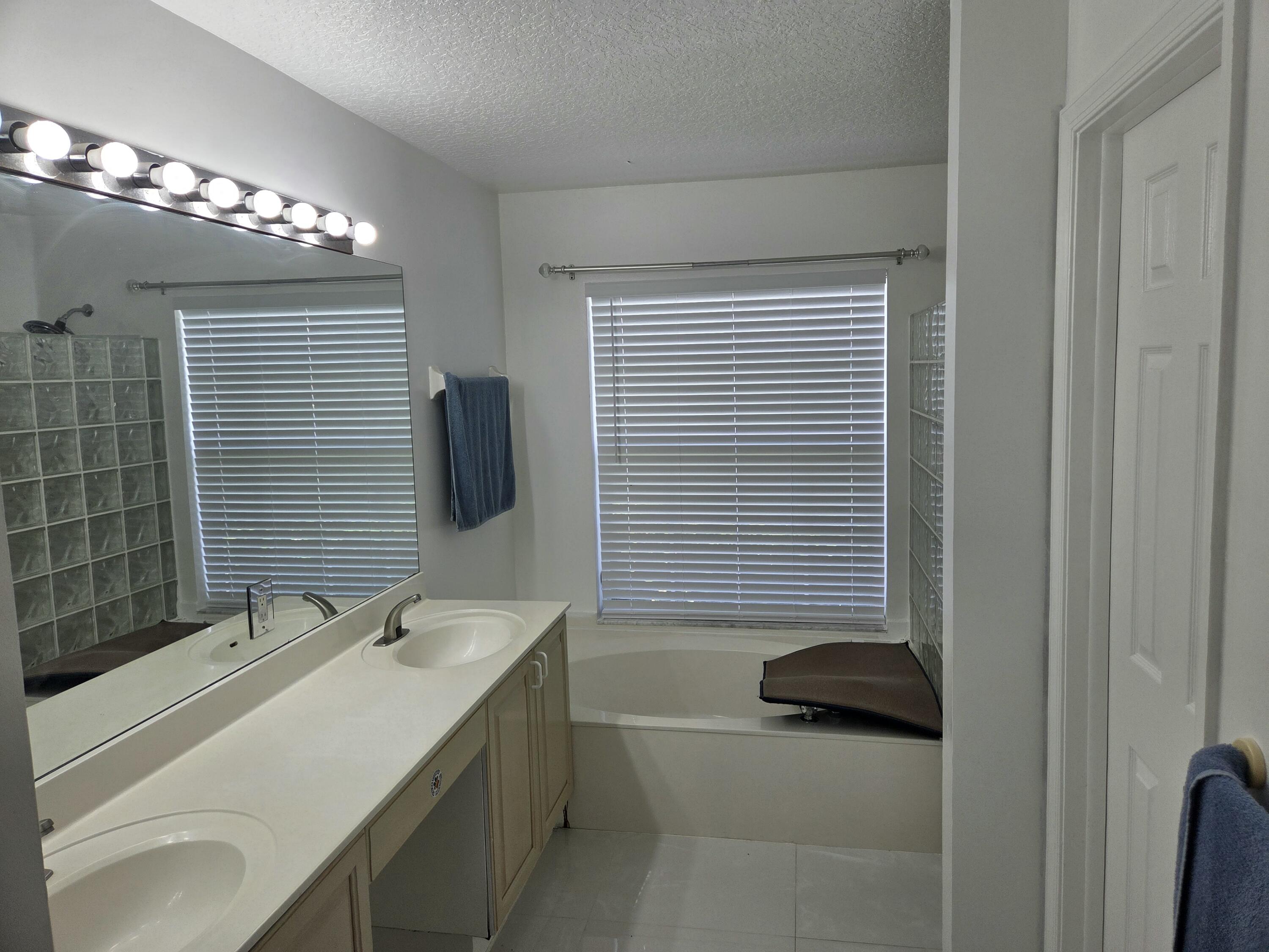 3021 Casa Rio Court Riviera Beach, FL 33418 - Photo 6 of 16 a bathroom with a sink double vanity and a mirror