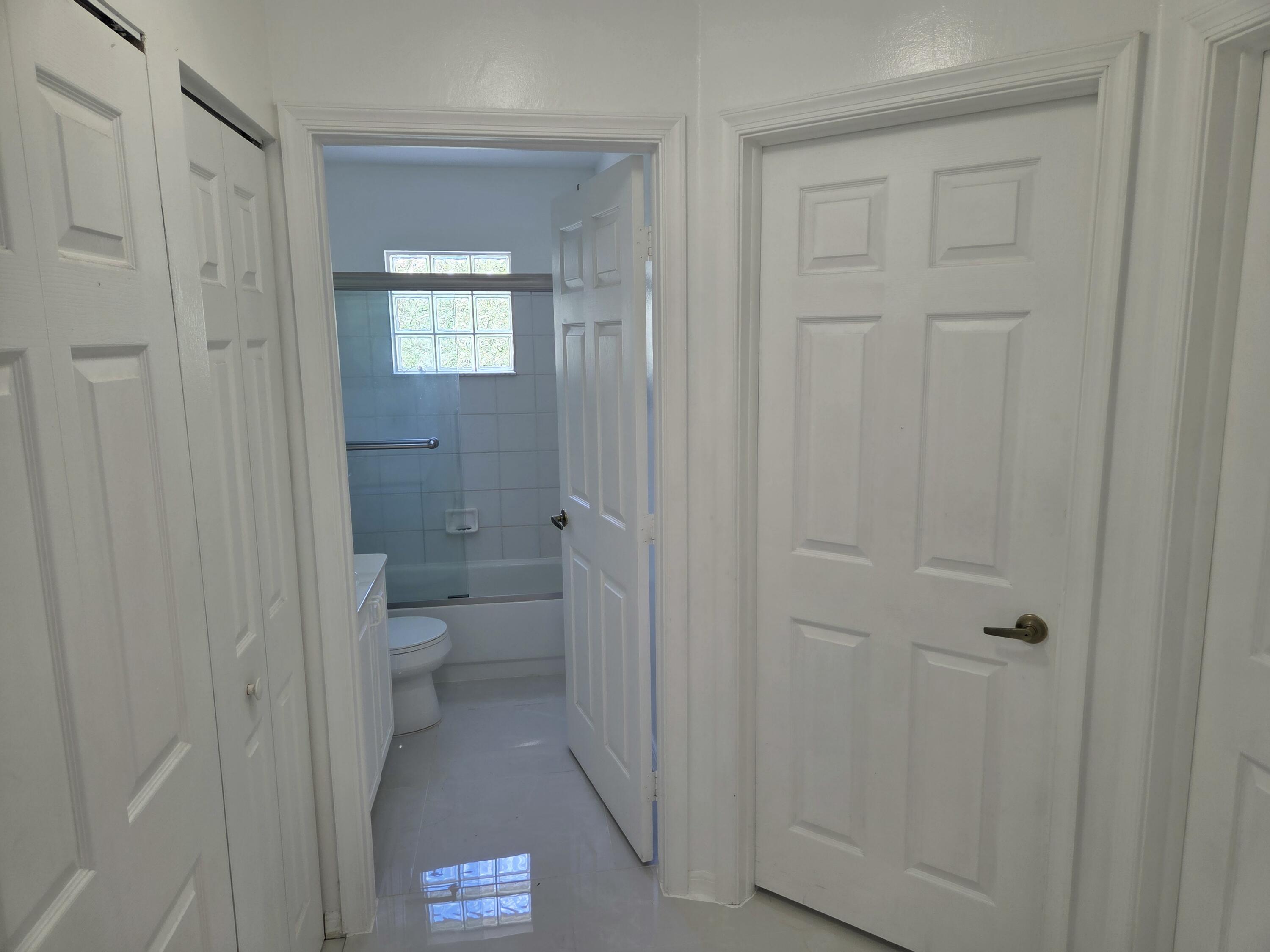 3021 Casa Rio Court Riviera Beach, FL 33418 - Photo 10 of 16 a bathroom with a toilet shower and a sink