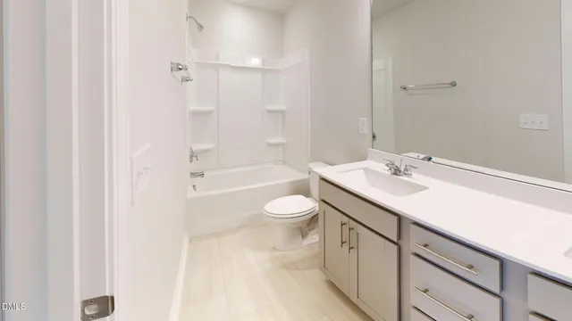 a bathroom with a granite countertop sink toilet a bathtub and shower