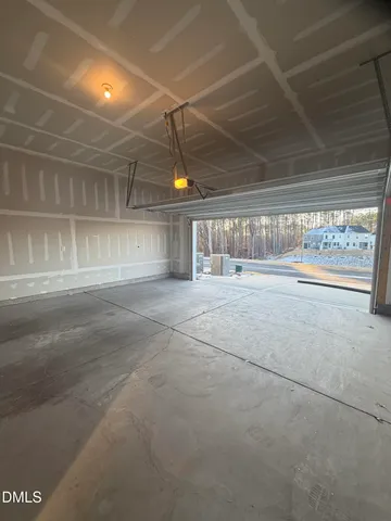a room with natural light and wooden cabinets