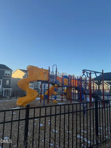 a view of a patio with dining table and chairs next to a yard