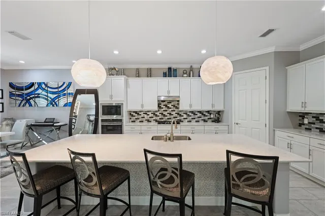 a kitchen with a dining table and chairs