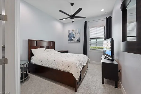 a bedroom with a bed and a desk with wooden floor