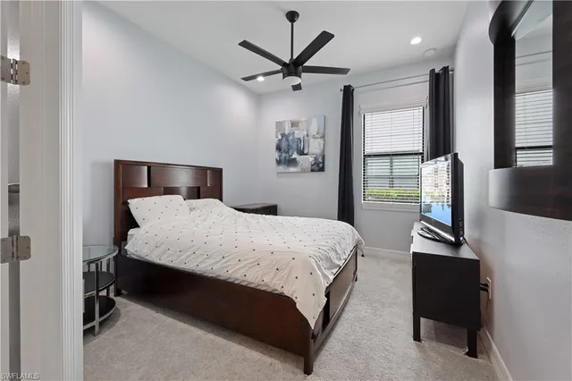 a bedroom with a bed and a desk with wooden floor