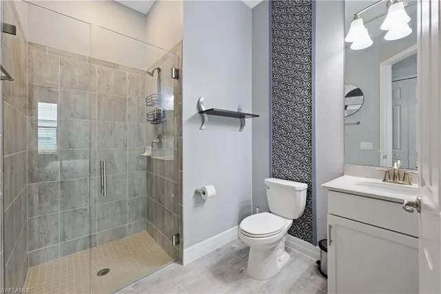 a bathroom with a toilet a sink and shower