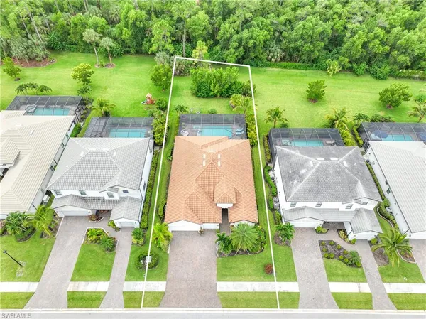 an aerial view of ocean with yard