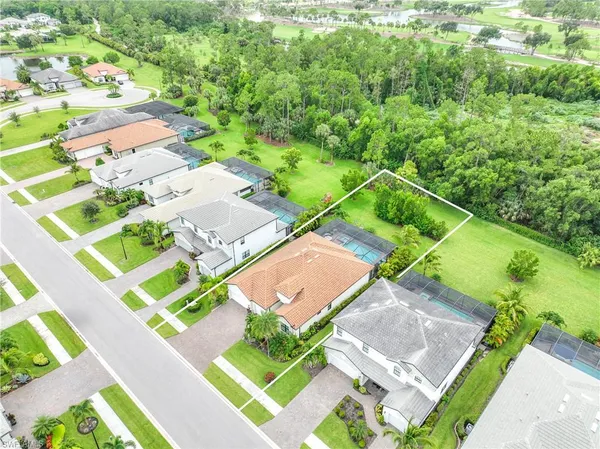 an aerial view of a house with a garden and swimming pool