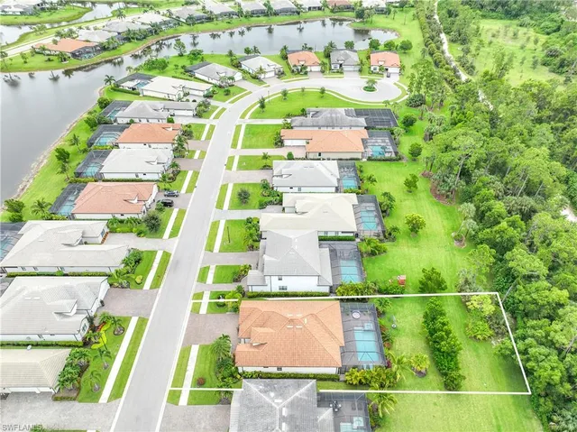 an aerial view of residential houses with outdoor space and street view