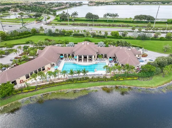 an aerial view of a house with a garden and lake view