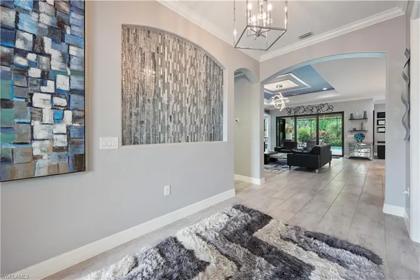 a bedroom with furniture and a chandelier