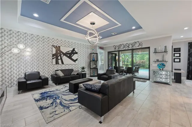 a living room with furniture and a chandelier