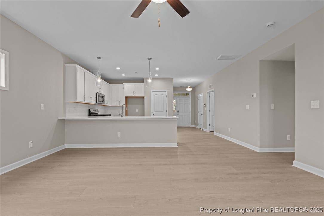 274 Rough Ridge Trail Aberdeen, NC 28315 - Photo 15 of 47 a living room with kitchen island furniture and a ceiling fan