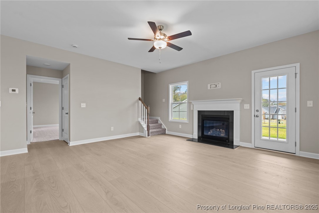 274 Rough Ridge Trail Aberdeen, NC 28315 - Photo 19 of 47 an empty room with fireplace and windows