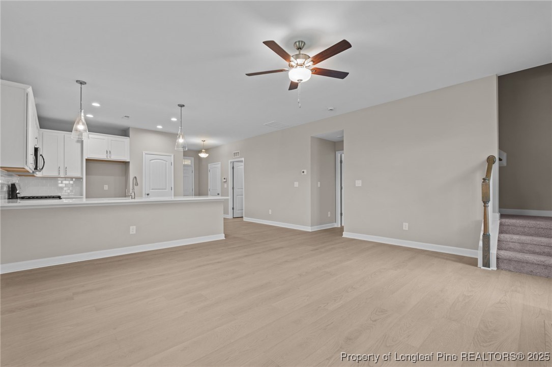 274 Rough Ridge Trail Aberdeen, NC 28315 - Photo 20 of 47 a view of an empty room with kitchen appliances and a ceiling fan