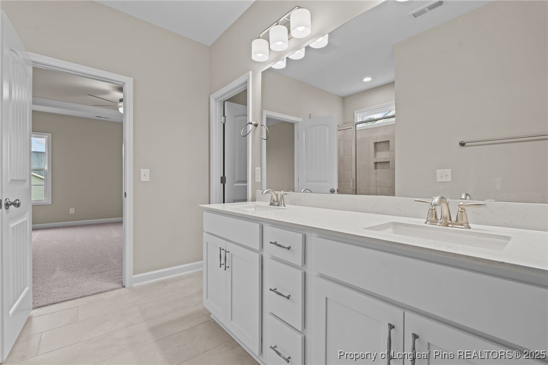 274 Rough Ridge Trail Aberdeen, NC 28315 - Photo 23 of 47 a bathroom with a sink a vanity and a mirror