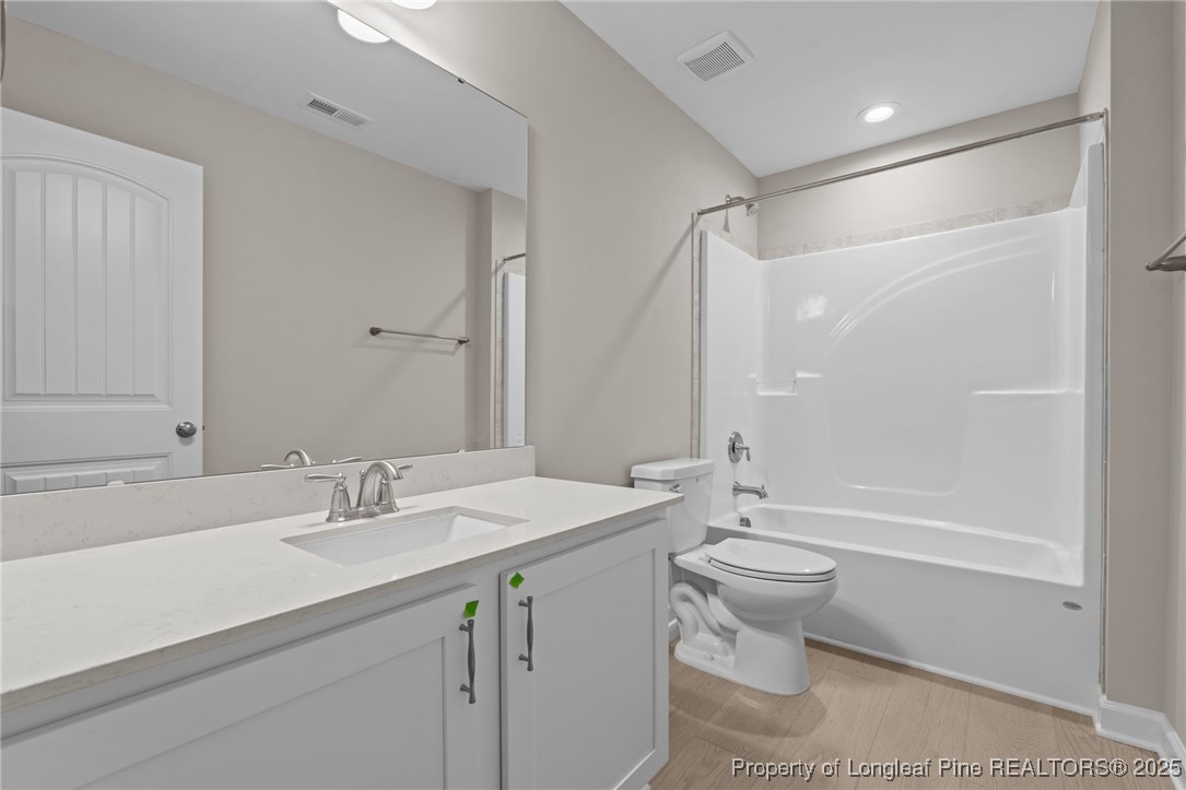 274 Rough Ridge Trail Aberdeen, NC 28315 - Photo 30 of 47 a bathroom with a double vanity sink toilet and shower