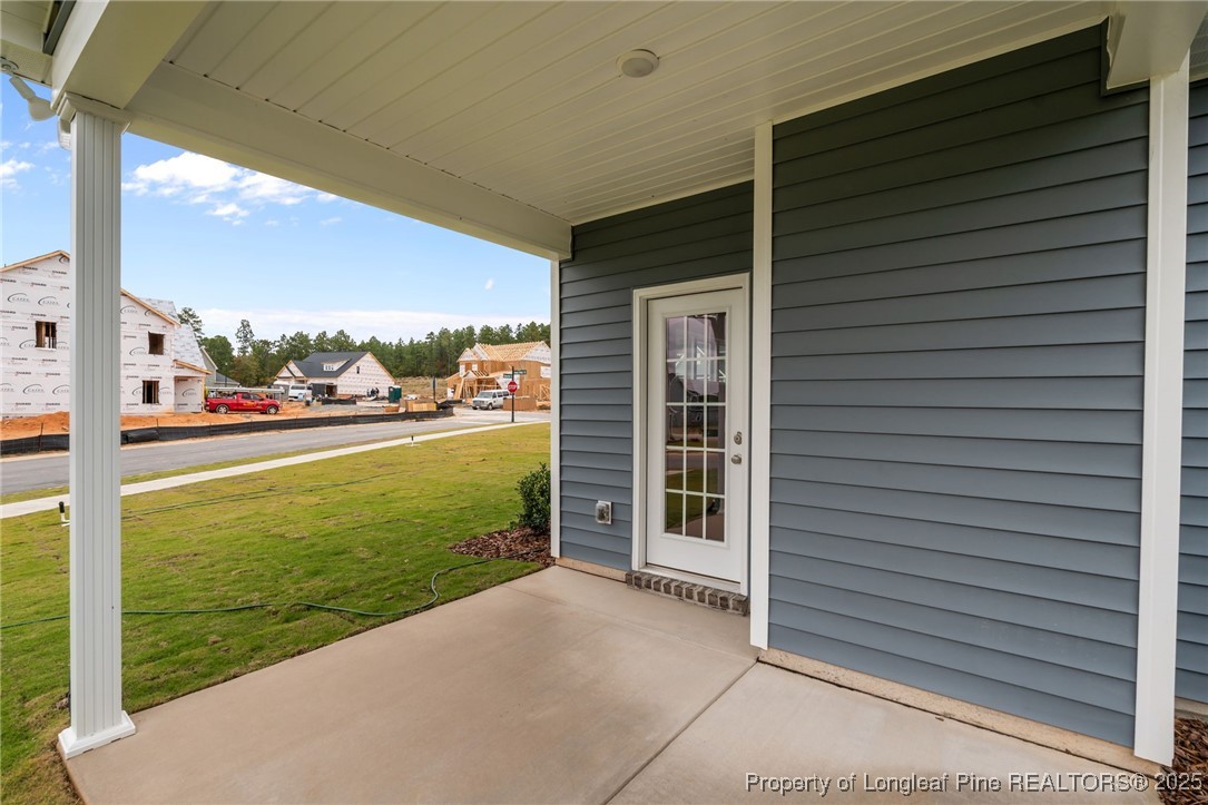 274 Rough Ridge Trail Aberdeen, NC 28315 - Photo 45 of 47 a view of a patio with a table and chairs