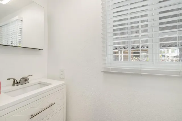 a bathroom with a sink double vanity and a mirror