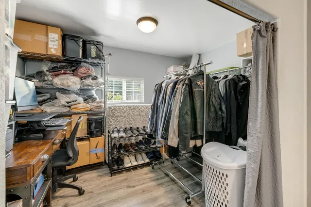 a bedroom with a bed and a large mirror