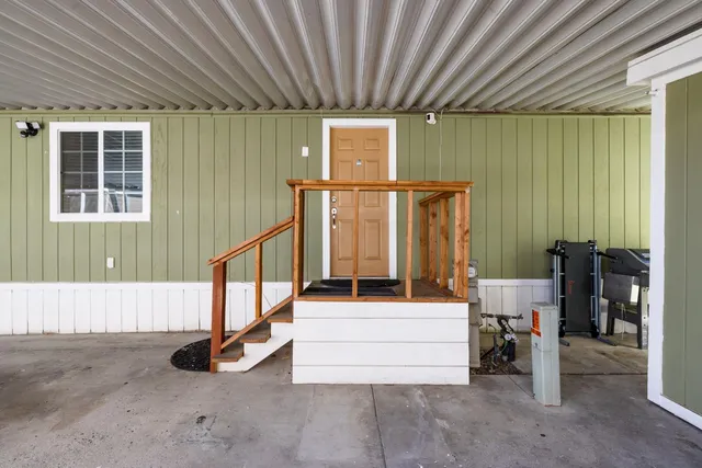 a bathroom with a double vanity sink and a potted plant
