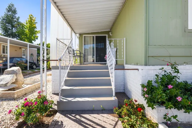 a kitchen with sink a stove and chairs