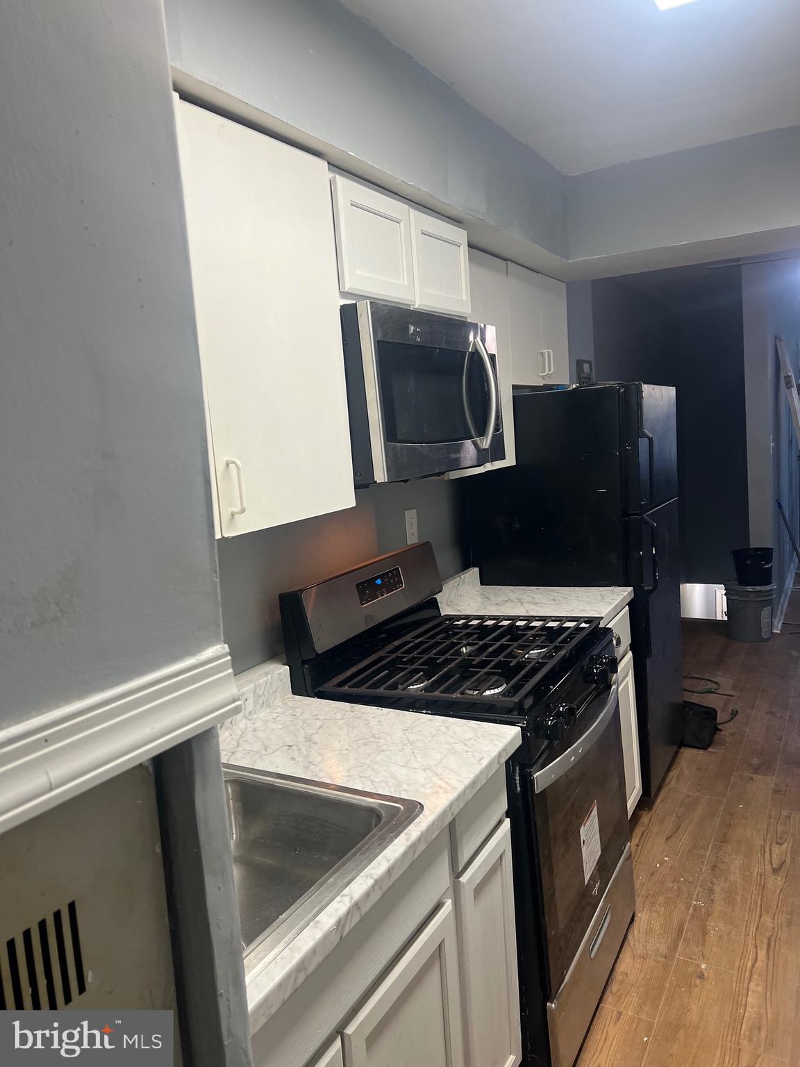 5047 Benning Road Southeast, Unit B Washington, DC 20019 - Photo 11 of 19 a kitchen with a stove and a microwave