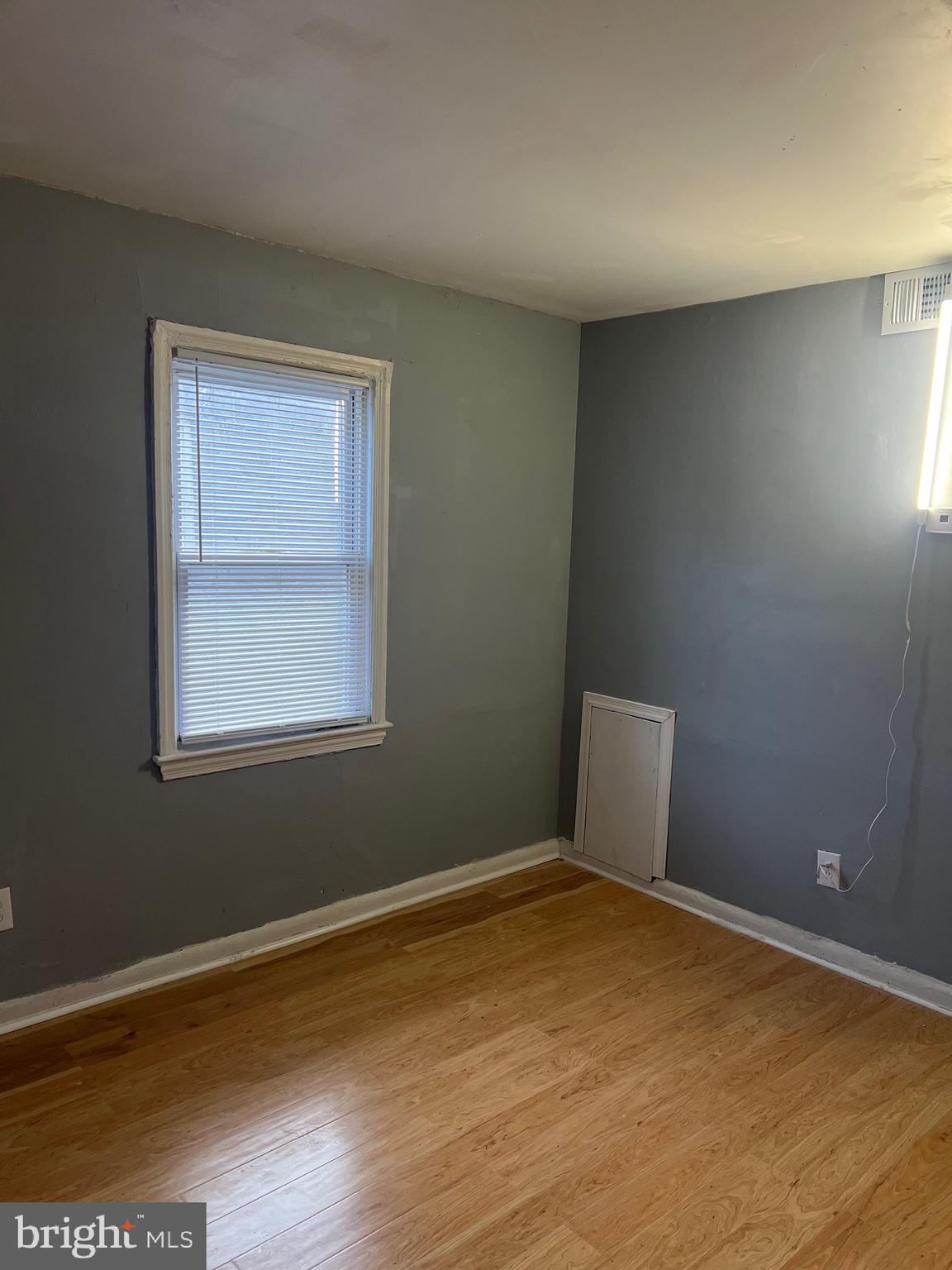 5047 Benning Road Southeast, Unit B Washington, DC 20019 - Photo 12 of 19 a view of a room with wooden floor and window