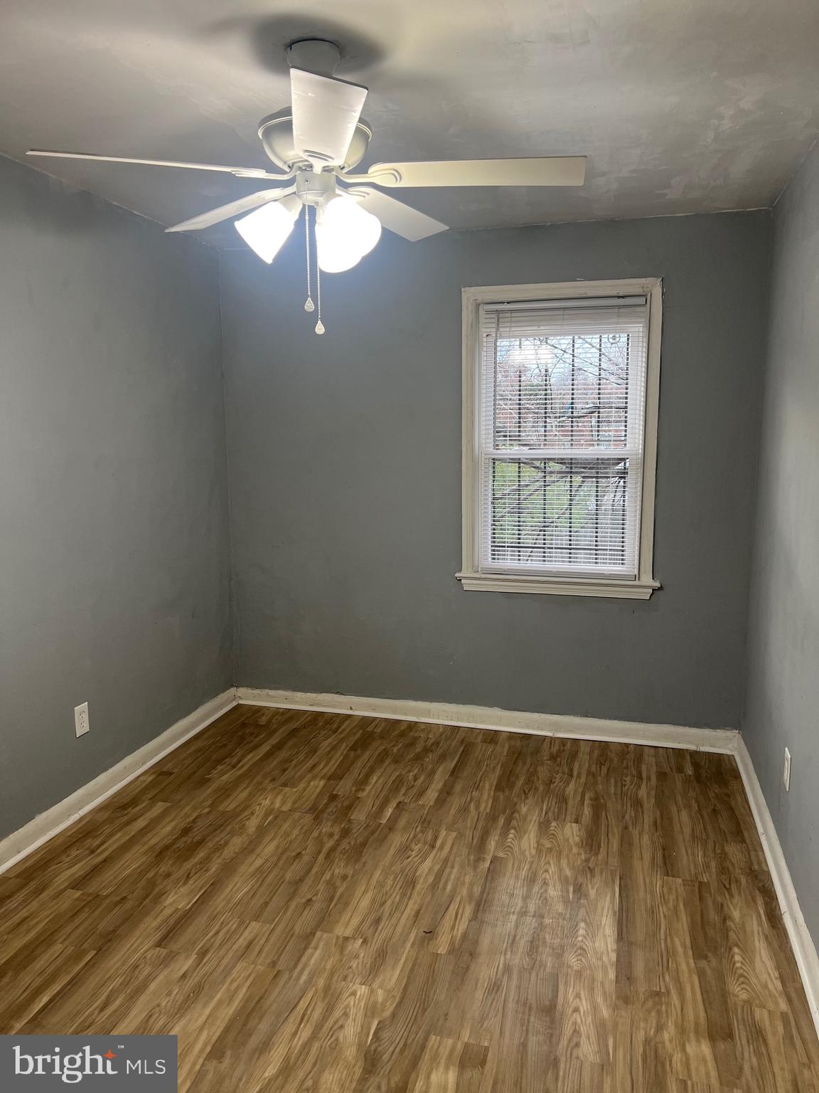 5047 Benning Road Southeast, Unit B Washington, DC 20019 - Photo 16 of 19 a view of an empty room with wooden floor and a window