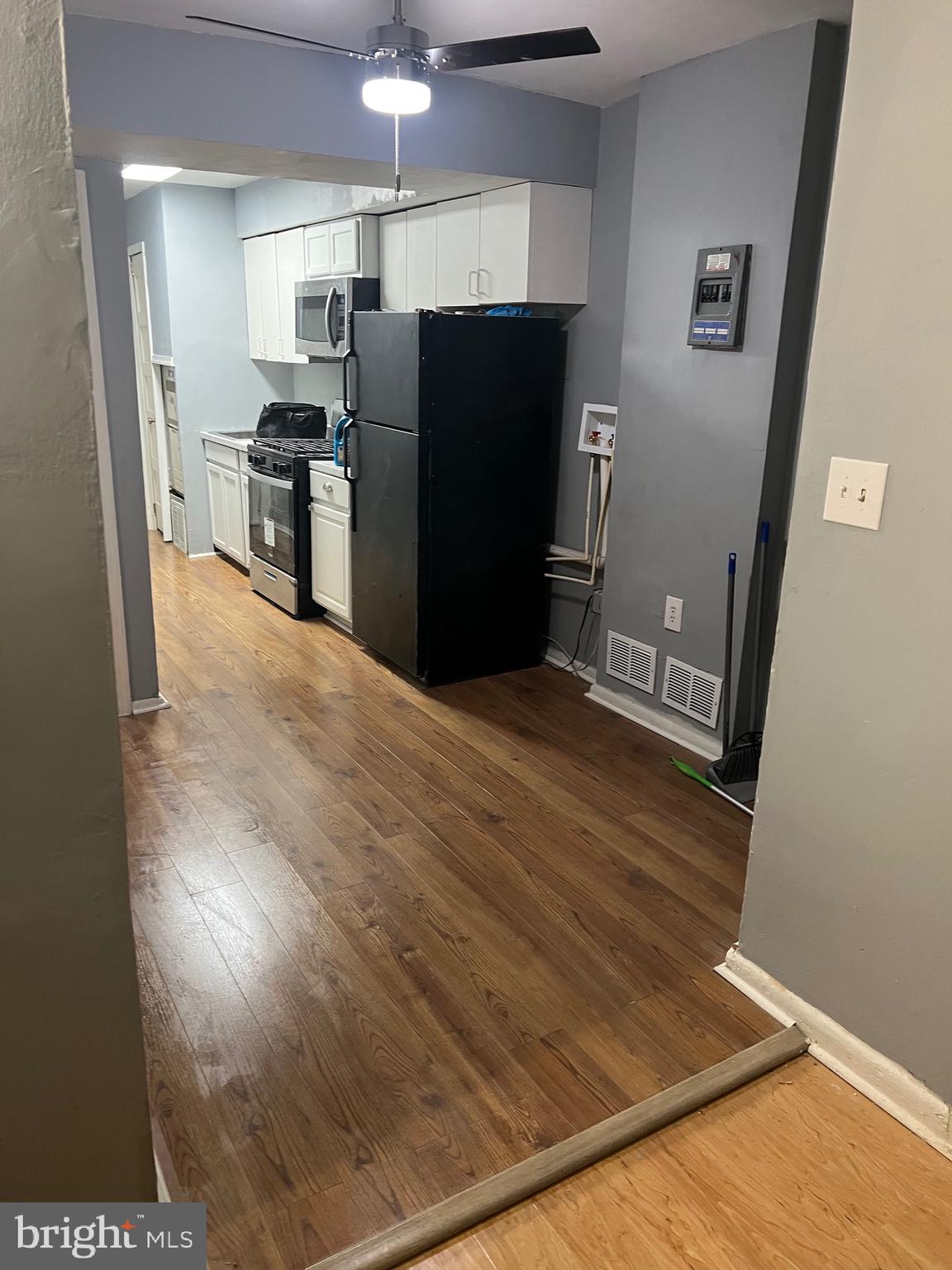 5047 Benning Road Southeast, Unit B Washington, DC 20019 - Photo 2 of 19 a view of kitchen with refrigerator stove and wooden floor