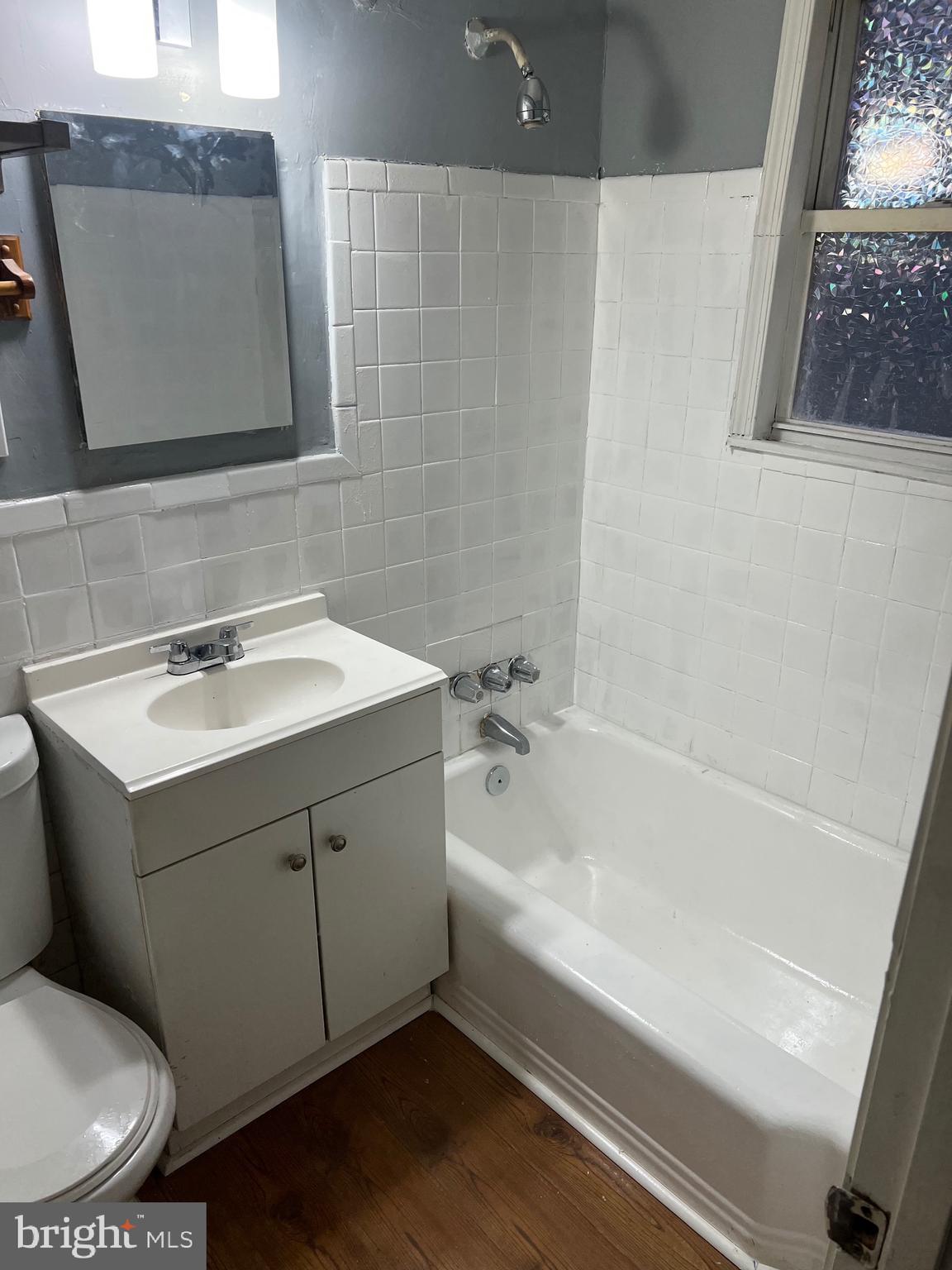 5047 Benning Road Southeast, Unit B Washington, DC 20019 - Photo 4 of 20 a bathroom with a sink and a bathtub