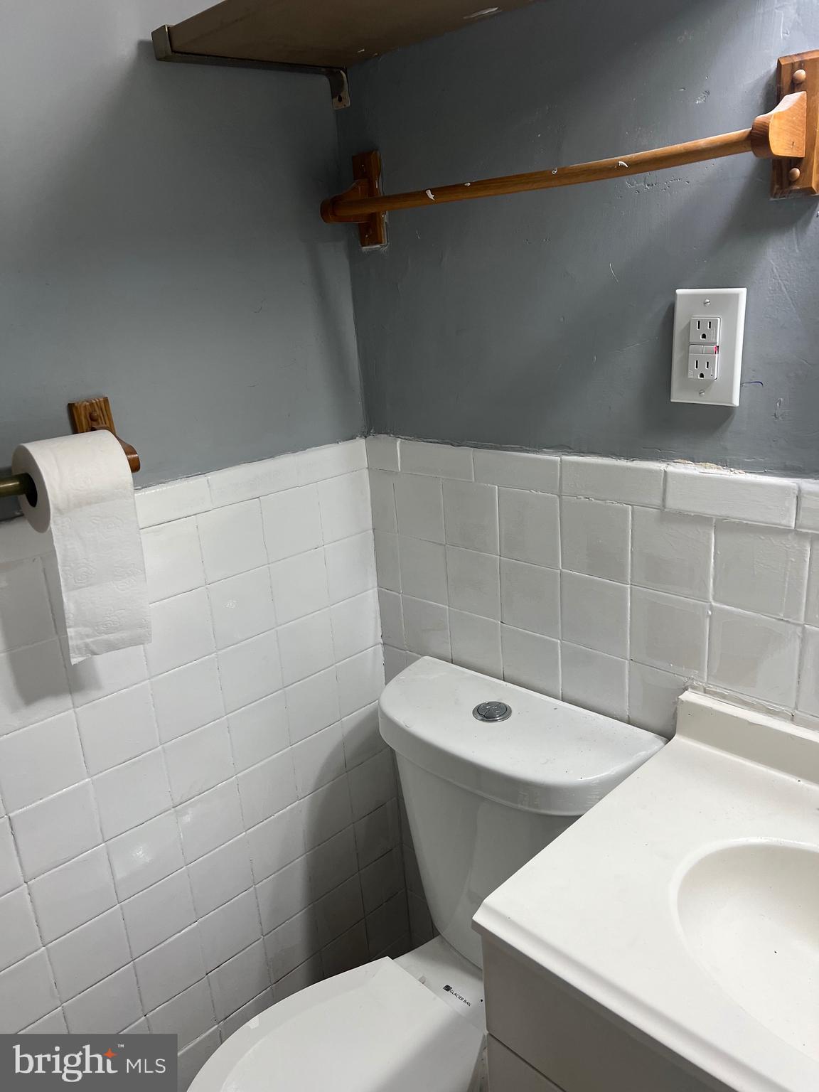 5047 Benning Road Southeast, Unit B Washington, DC 20019 - Photo 5 of 20 a bathroom with a sink a toilet and a mirror