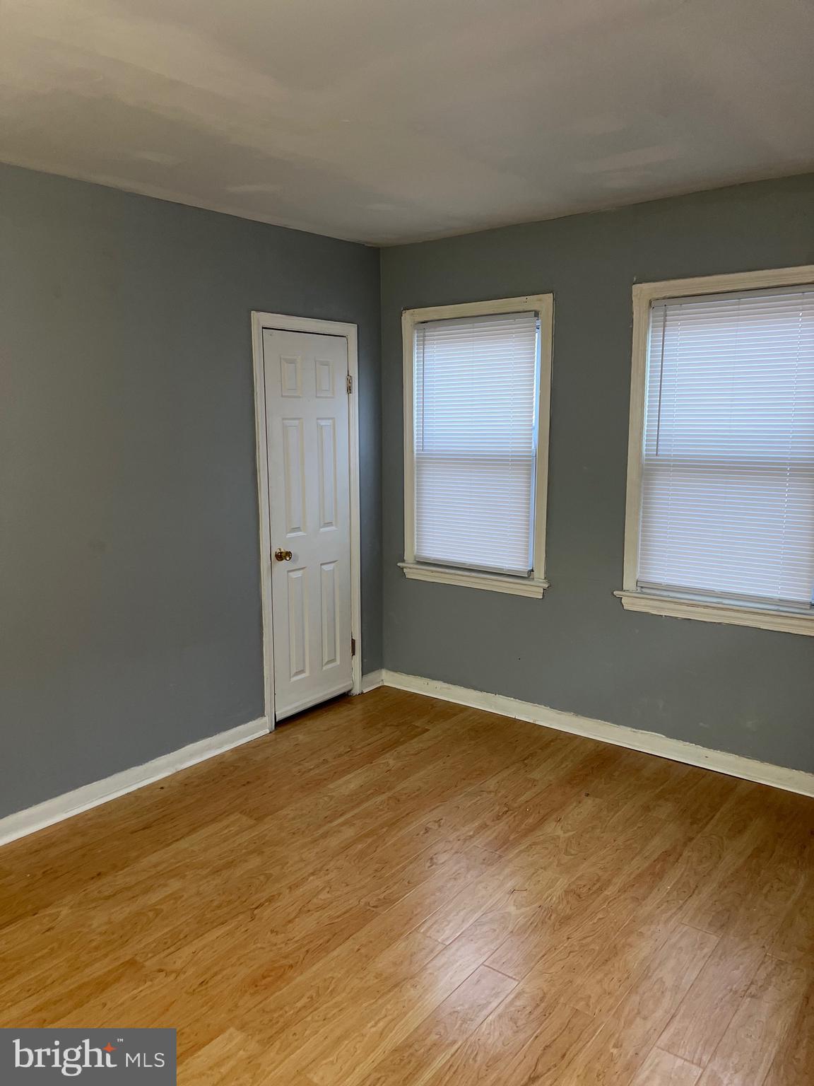 5047 Benning Road Southeast, Unit B Washington, DC 20019 - Photo 10 of 19 an empty room with wooden floor and windows