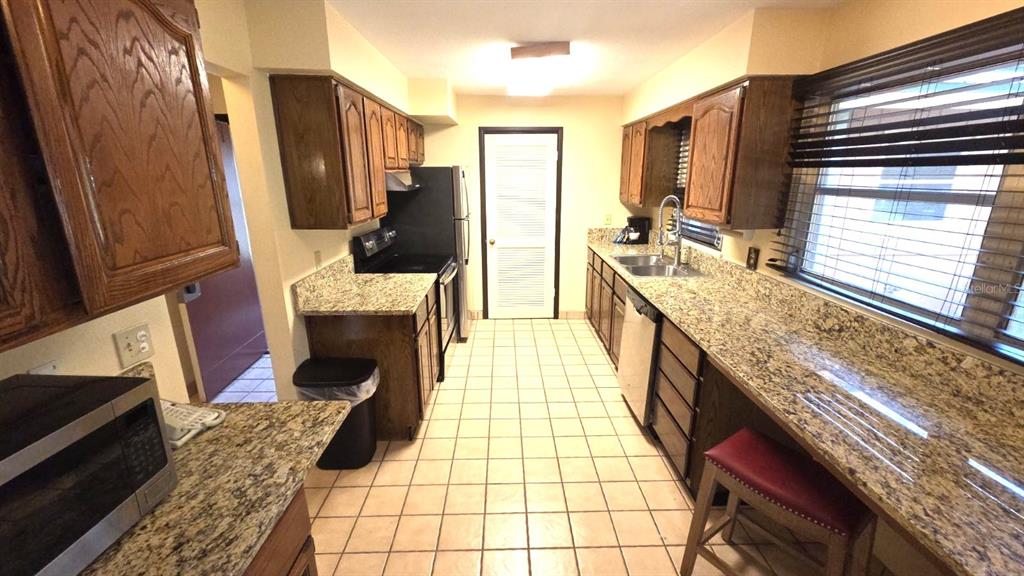 454 Cottage Circle, Unit 454 River Ranch, FL 33867 - Photo 12 of 27 a bathroom with a granite countertop double vanity sink and a mirror