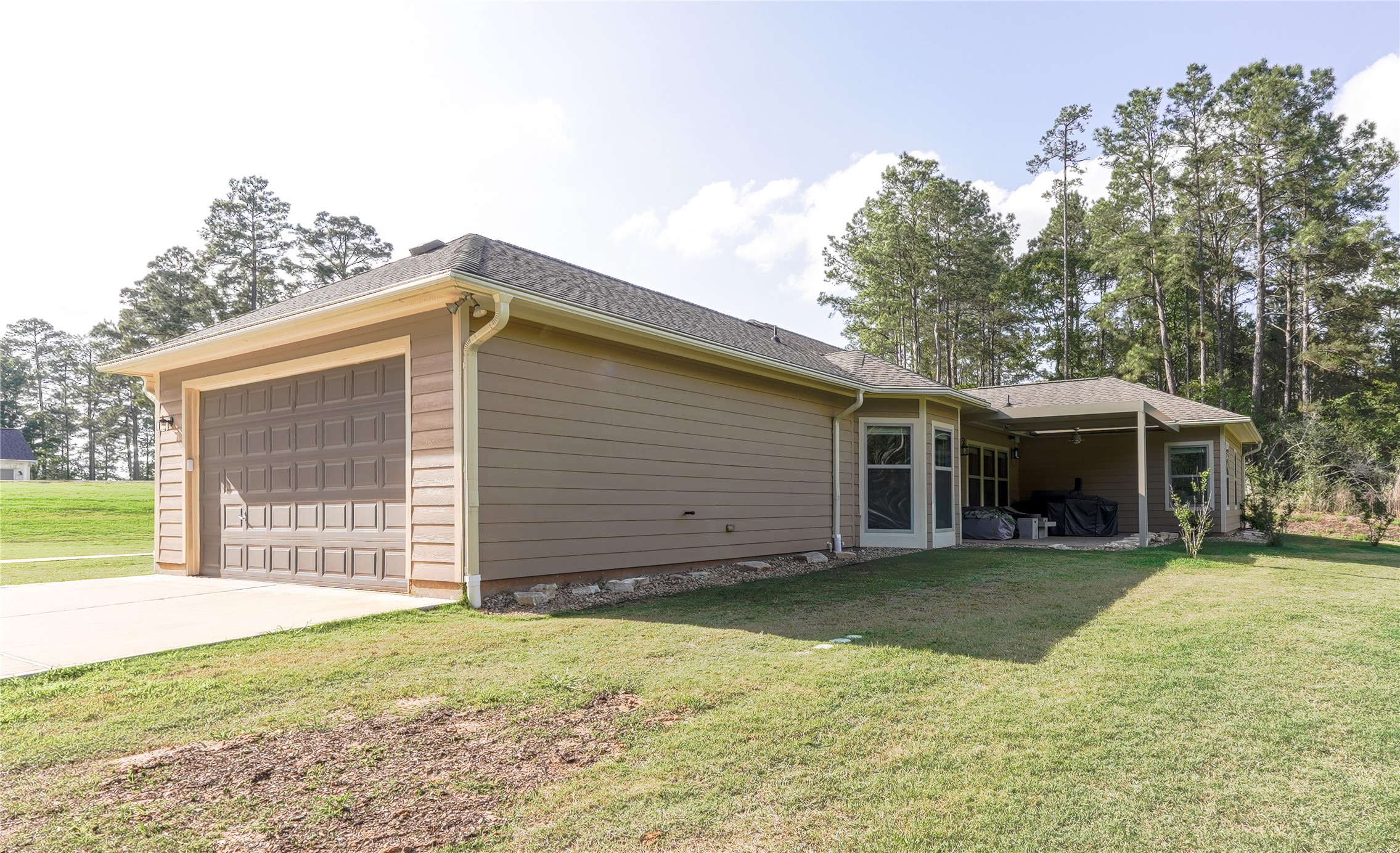 120 Sanctuary Road Huntsville, TX 77340 - Photo 30 of 38 a view of a house with a yard and large tree