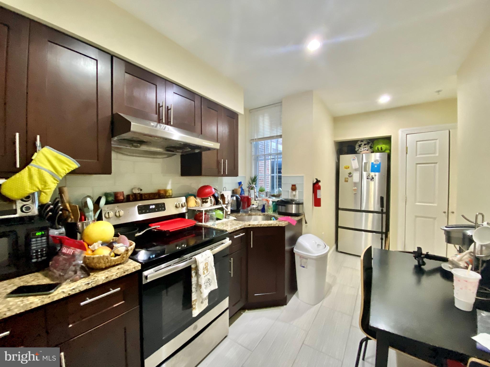 a kitchen with stainless steel appliances a sink a stove and refrigerator