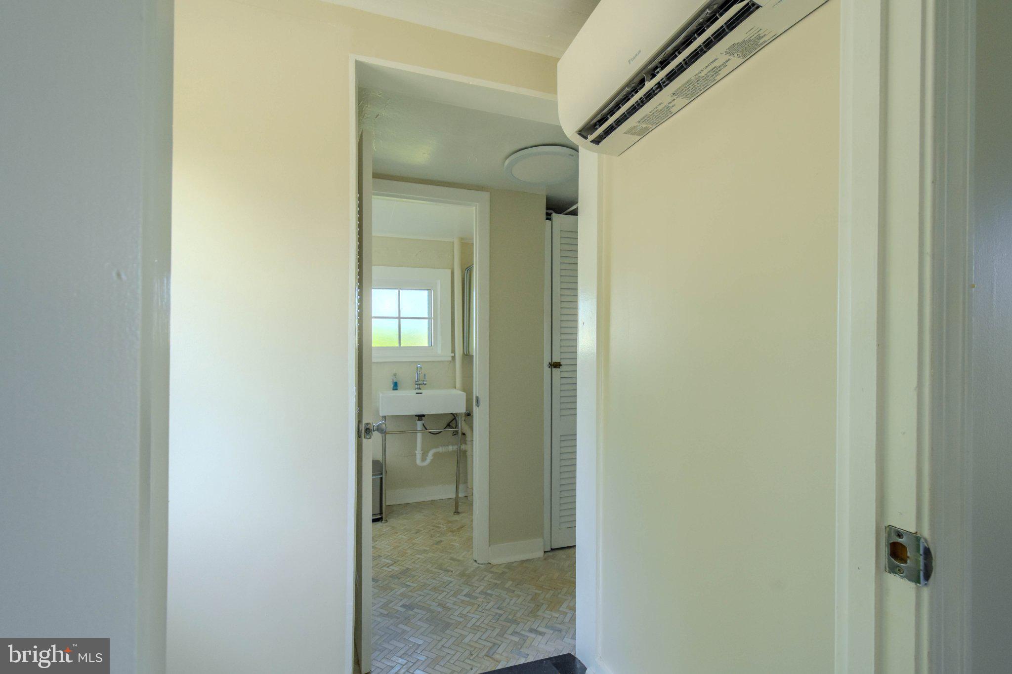 6062 Drum Point Road Deale, MD 20751 - Photo 13 of 17 Bright and airy hallway leads to bath.