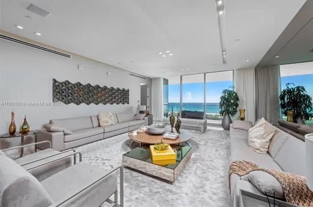 a living room with furniture kitchen view and a large window