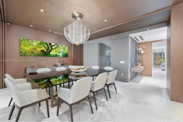 a view of a dining room with furniture a chandelier and wooden floor