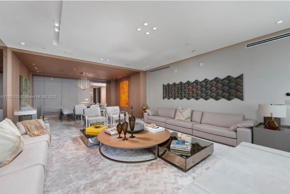 9349 Collins Avenue, Unit 304 Surfside, FL 33154 - Photo 13 of 40 a living room with furniture and a table