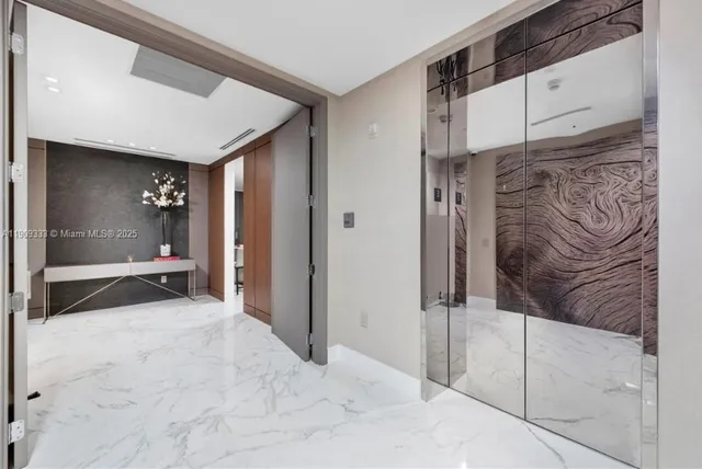a view of a hallway with wooden cabinets