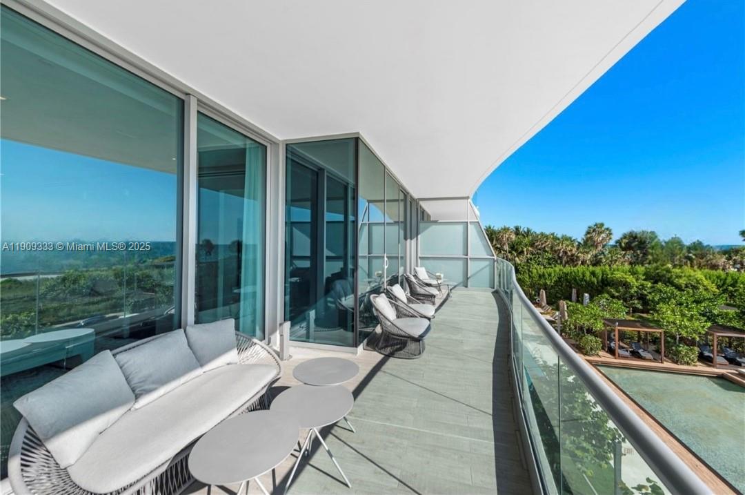 9349 Collins Avenue, Unit 304 Surfside, FL 33154 - Photo 16 of 40 a balcony with furniture and a potted plant