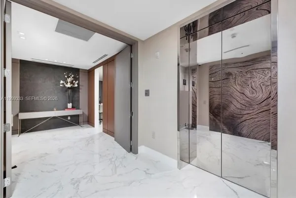 a large white kitchen with a large window