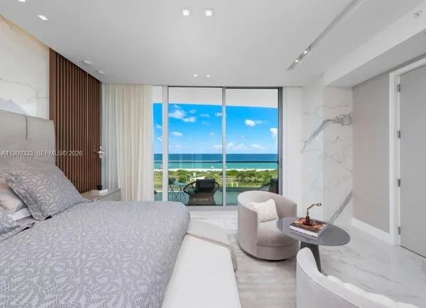 a living room with furniture a window and a flat screen tv