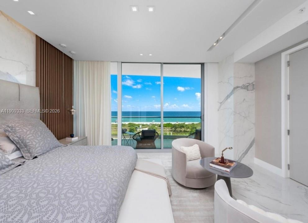 9349 Collins Avenue, Unit 304 Surfside, FL 33154 - Photo 17 of 40 a bedroom with furniture and a large window