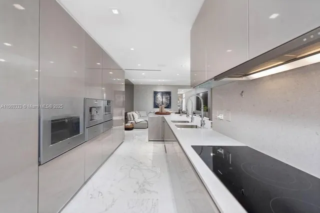 a large white kitchen with a large window