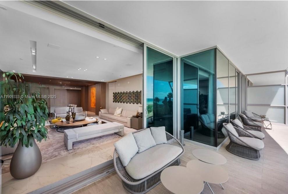 9349 Collins Avenue, Unit 304 Surfside, FL 33154 - Photo 2 of 40 a living room with furniture potted plant and a large window