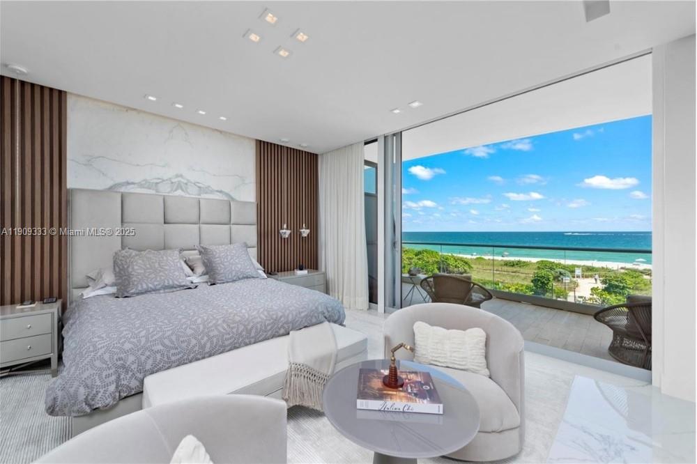 9349 Collins Avenue, Unit 304 Surfside, FL 33154 - Photo 24 of 40 a living room with furniture and a large window